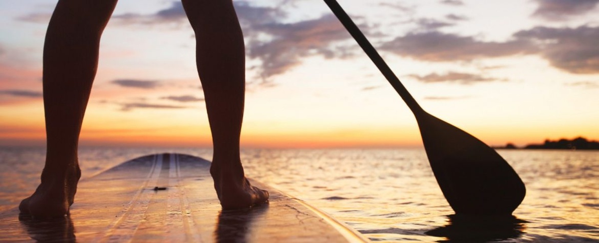 Paddleboarding at sunset on the ocean