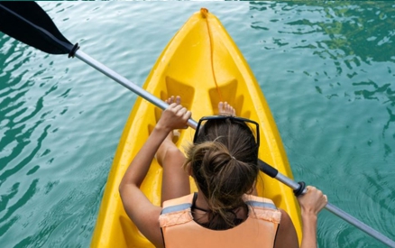 A woman kayaking on a lake