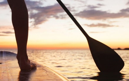Paddleboarding at sunset on the ocean